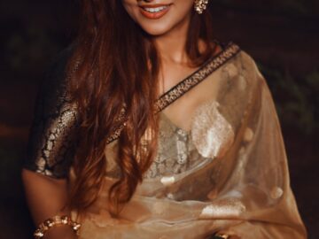 a woman in a sari holding a bowl of flowers